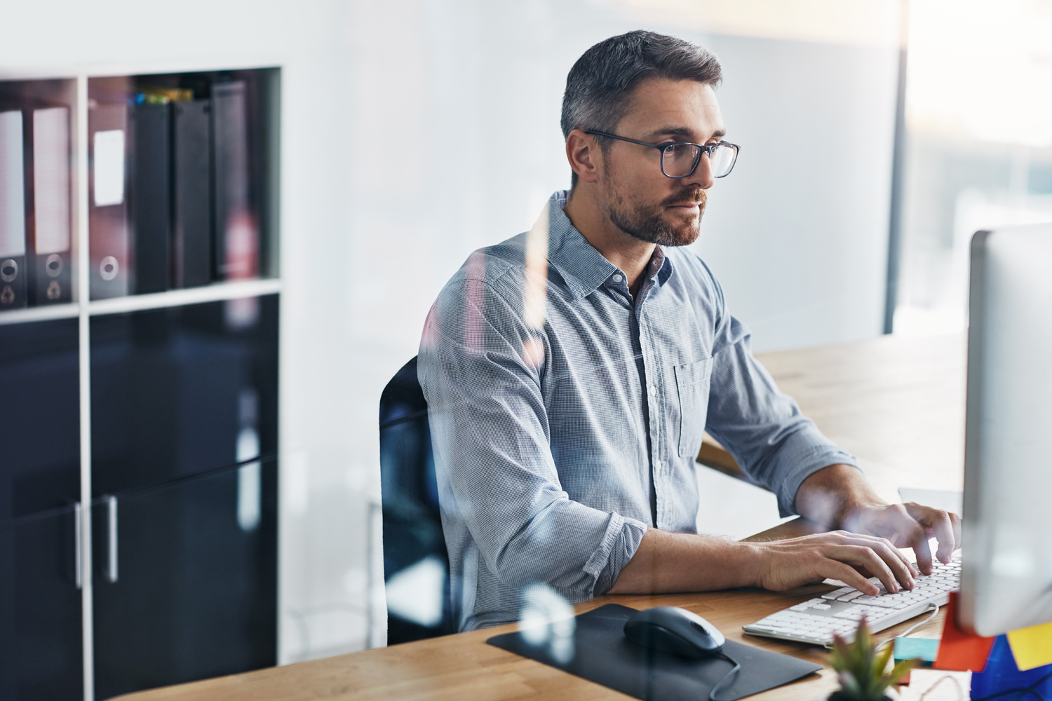 tech professional reviewing information on a computer