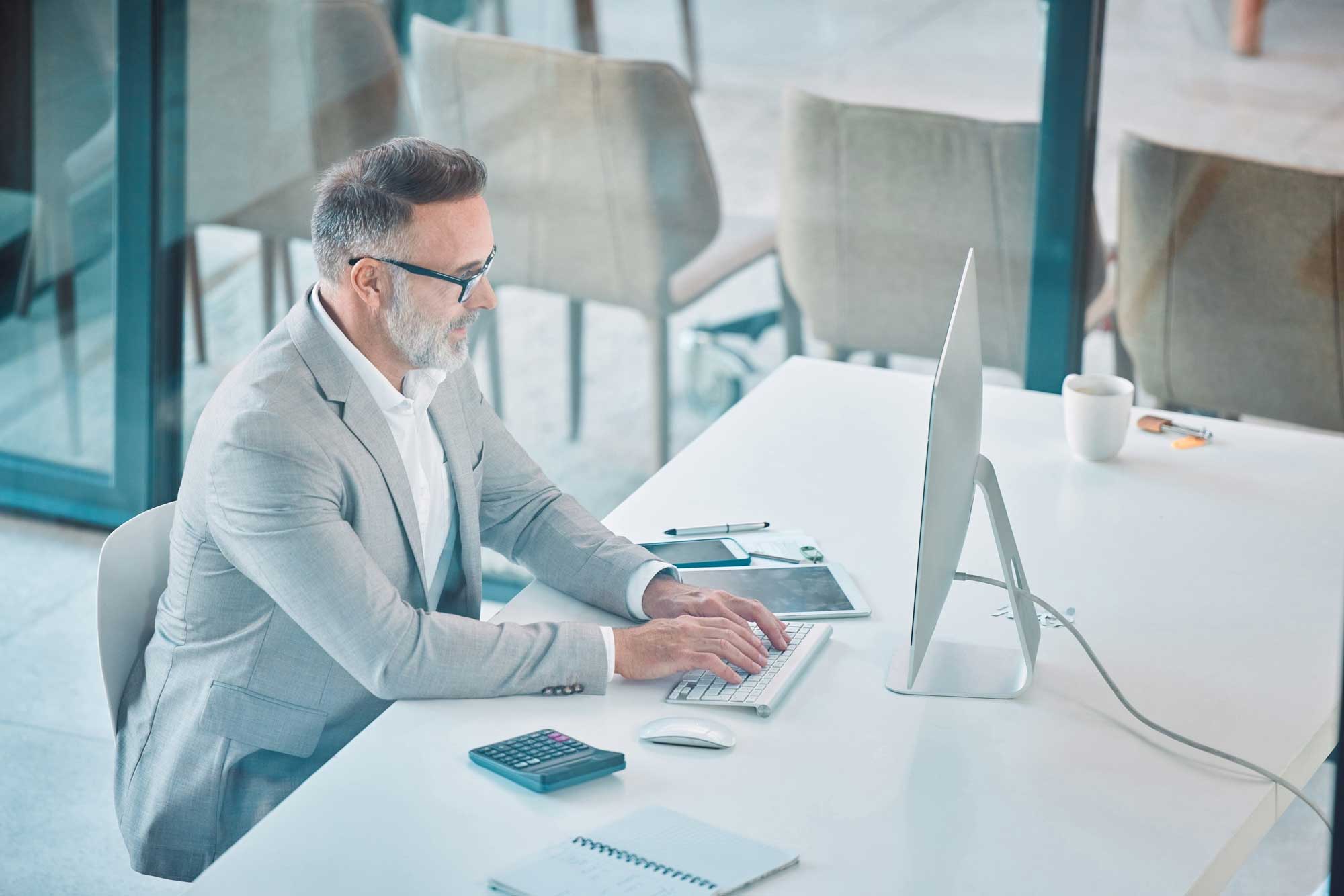 Finance, typing and mature man at computer with budget plan