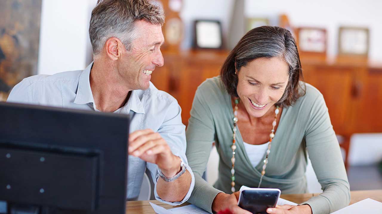 a mature couple calculating numbers together