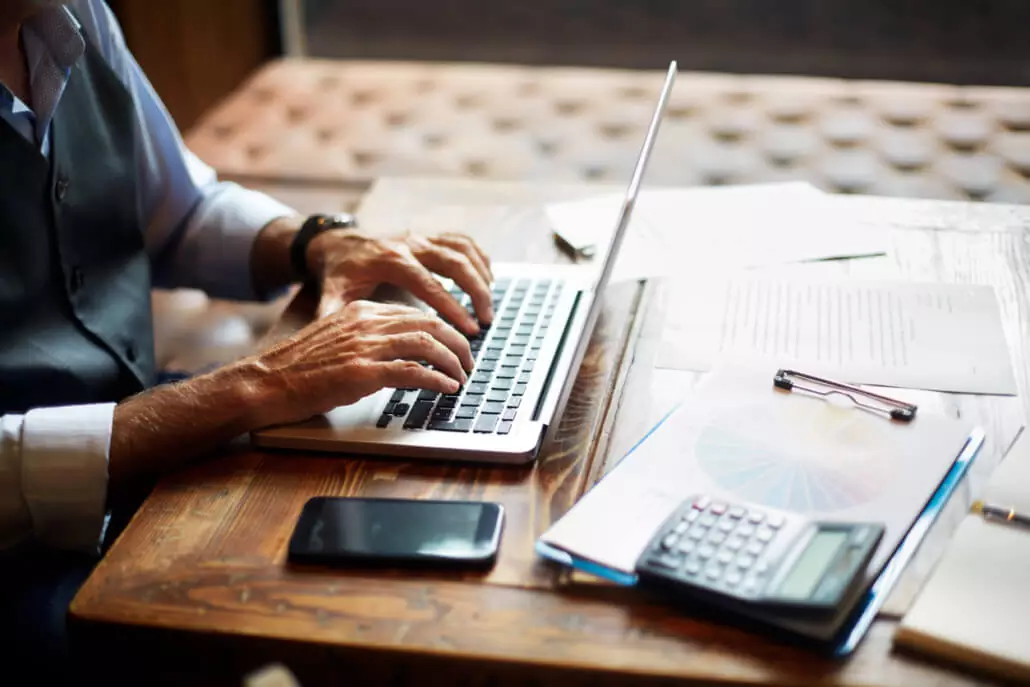 Person typing on the laptop