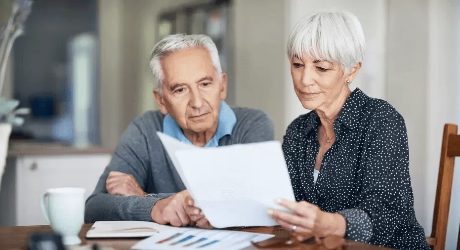 Retiree couple reading something on the paper